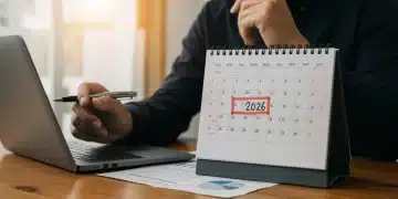 Small business owner planning for 2026 tax deductions with financial documents and laptop